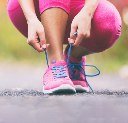 woman tying running shoe