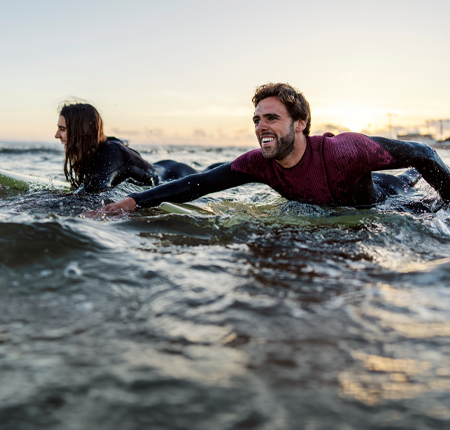 surfers paddling